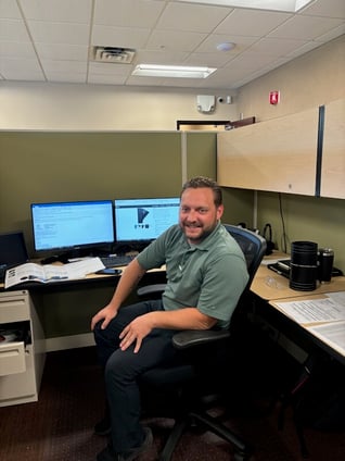 Jason posing at his desk