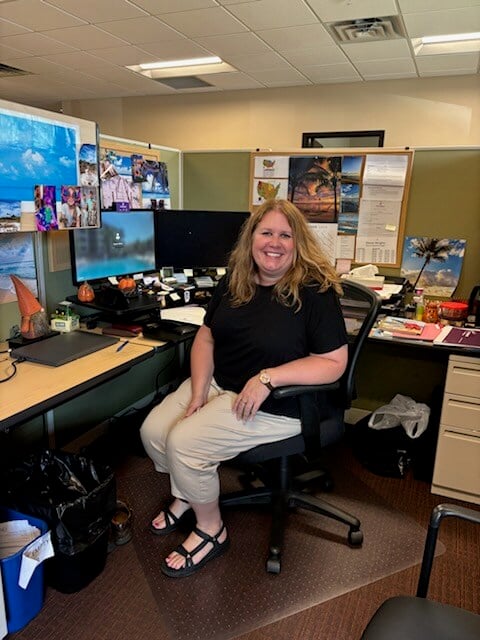 Shannon posing at her desk